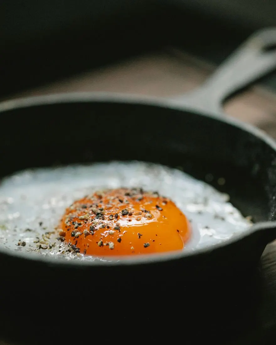 Two fried eggs in a cast iron pan