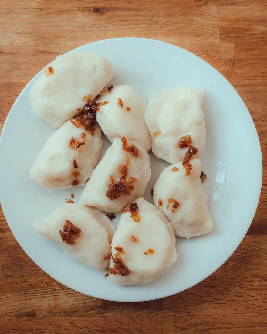 Plate of Polish pierogi with fried onions